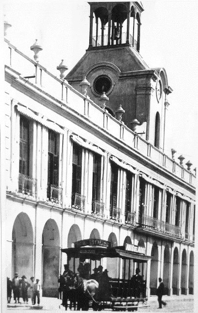 Historic City Hall. Historic photograph of the city hall with the tower and a horse-driven streetcar. Photograph credit: supplied by María Elena Ferreira